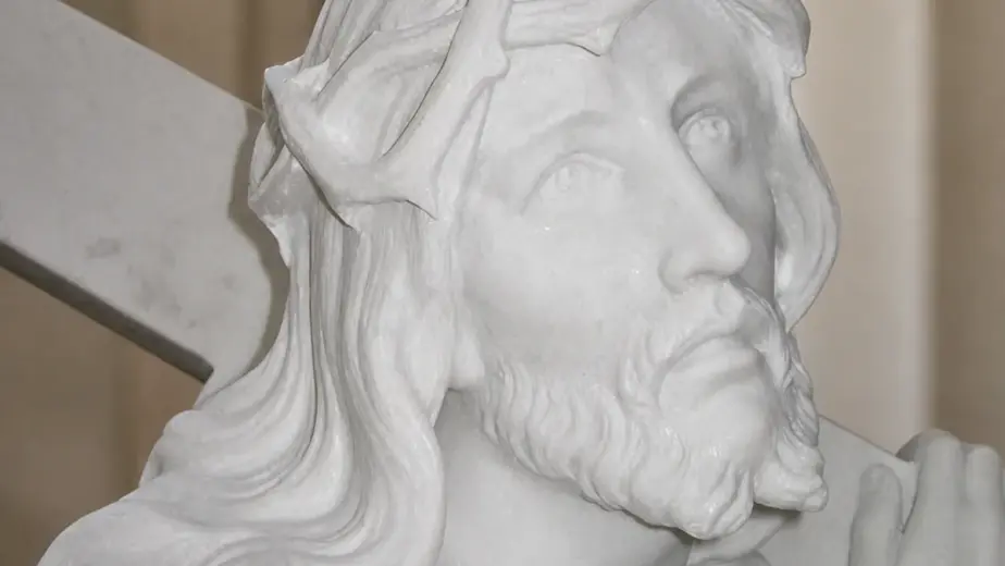 Cristo con croce in marmo bianco carrara, con primo piano del volto coronato di spine accanto alla croce